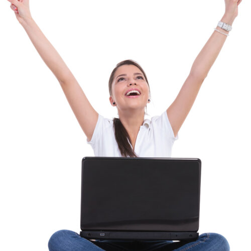 casual woman sits & cheers with laptop IT support montreal