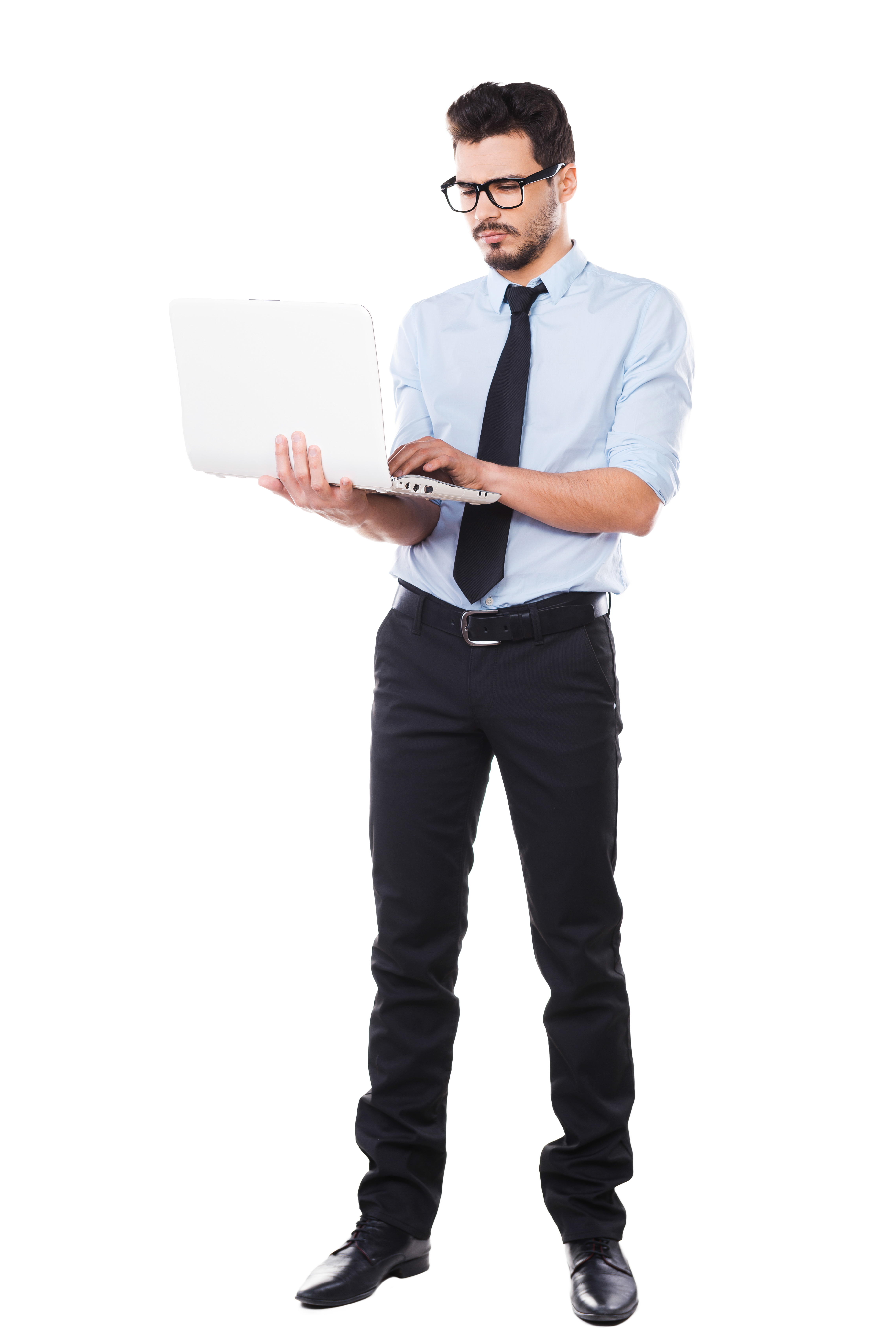 Supporting your business. Full length of handsome young man in shirt and tie working on laptop while standing against white background